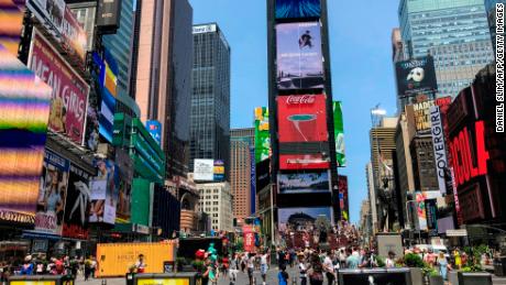 People walk around Times Square in New York City on July 9, 2019. 