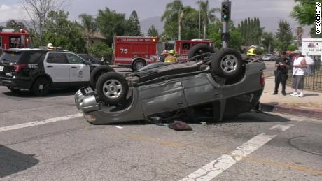 An car lies on its roof at the scene of Wednesday&#39;s accident.