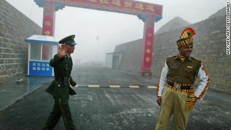 Guards stand at the India-China border. India&#39;s leaders may look to China&#39;s policies in Xinjiang and Tibet to control Kashmir. 