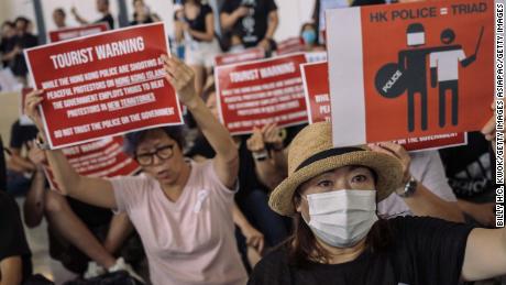 Protesters rally against a controversial extradition bill in the arrivals hall of the international airport on July 26, 2019, in Hong Kong, China. 