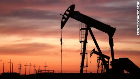 An oil pumpjack works at dawn in the Permian Basin oil field on January 20, 2016 in the oil town of Andrews, Texas.