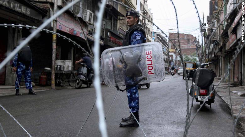 Rapid Action Force personnel stand guard at a roadblock ahead of the Muslim Friday noon prayers in Jammu on August 9, 2019.