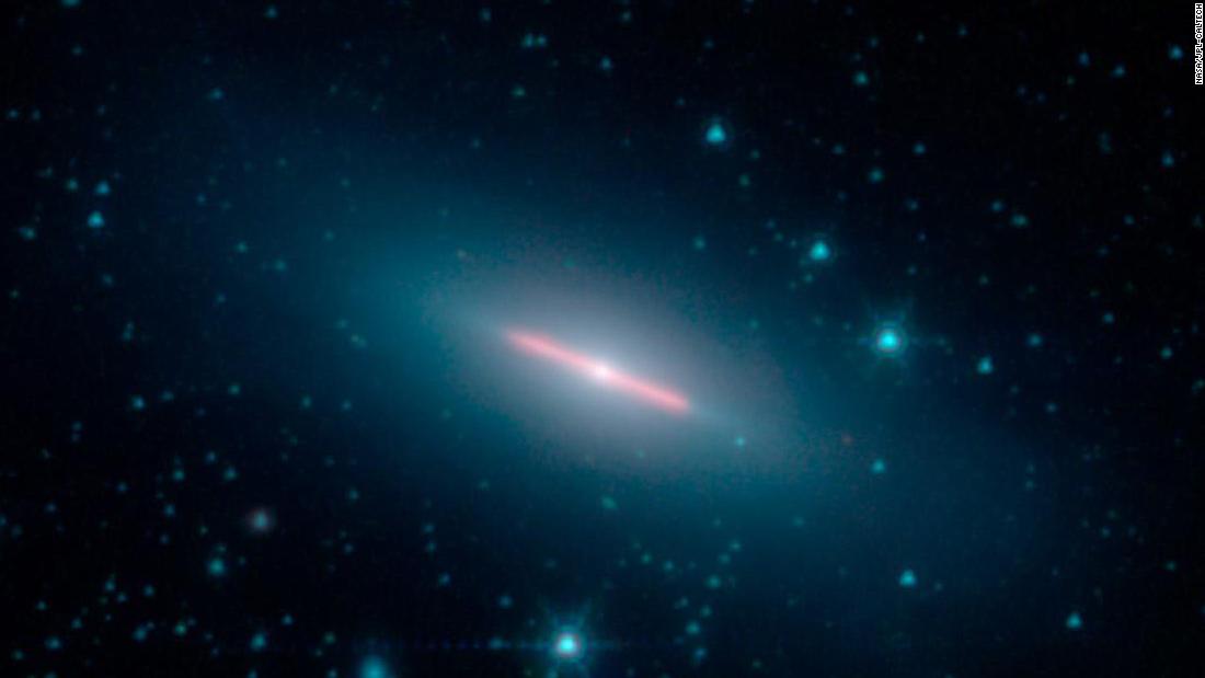 Galaxy NGC 5866 is 44 million light-years from Earth. It appears flat because we can only see its edge in this image captured by NASA&#39;s Spitzer Space Telescope.