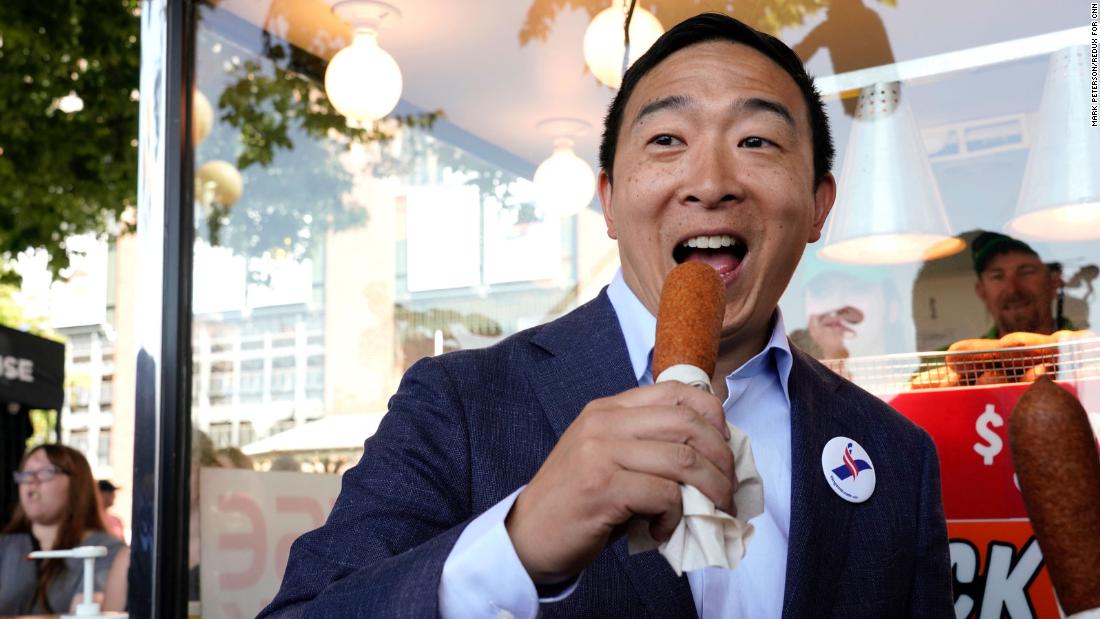 Yang enjoys a corn dog at the Iowa State Fair in August 2019.