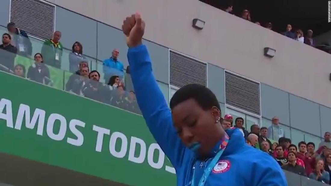 U.S. hammer thrower Gwen Berry raises her fist at the end of the national anthem at the Pan Am Games on Saturday.