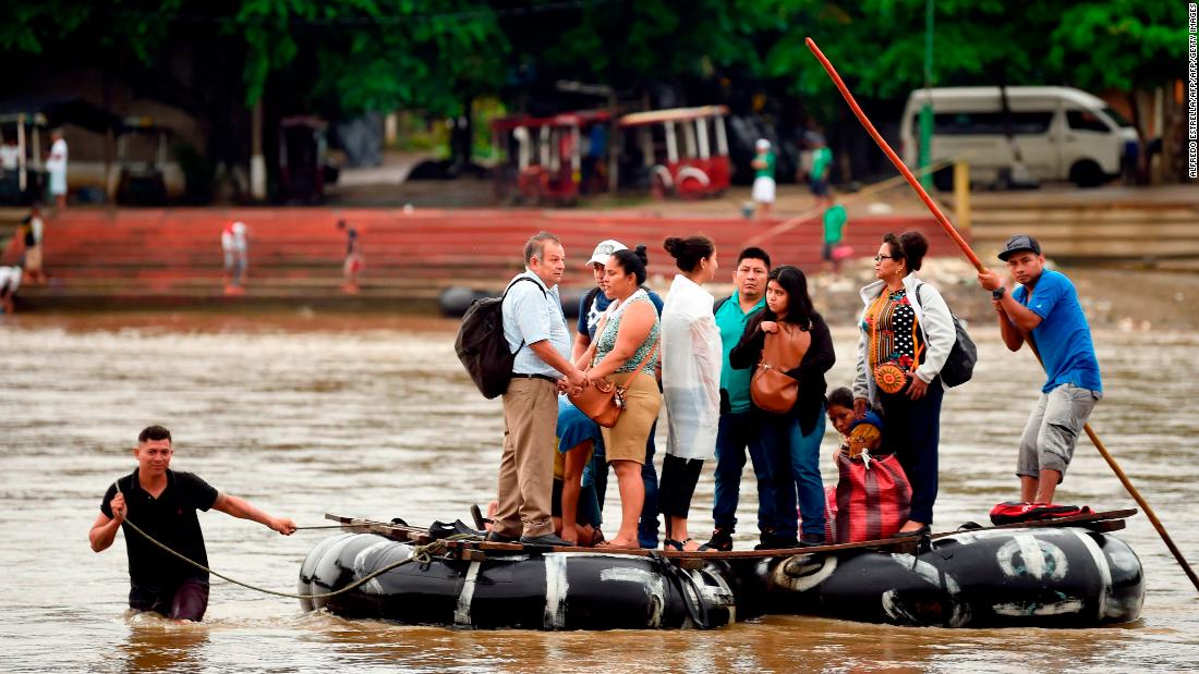 Guatemalan migrants use a makeshift raft to cross the Suchiate River from Guatemala to Mexico.