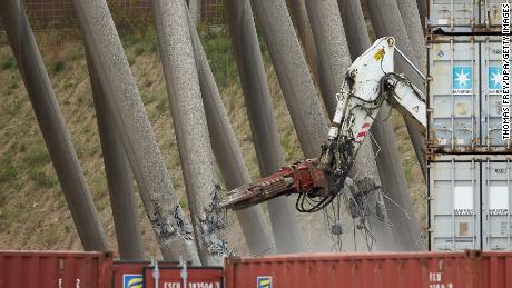 A robot weakens one of the supporting pillars of the cooling tower.