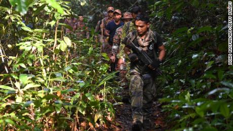 Members of a rescue team take part in the search effort on Monday.