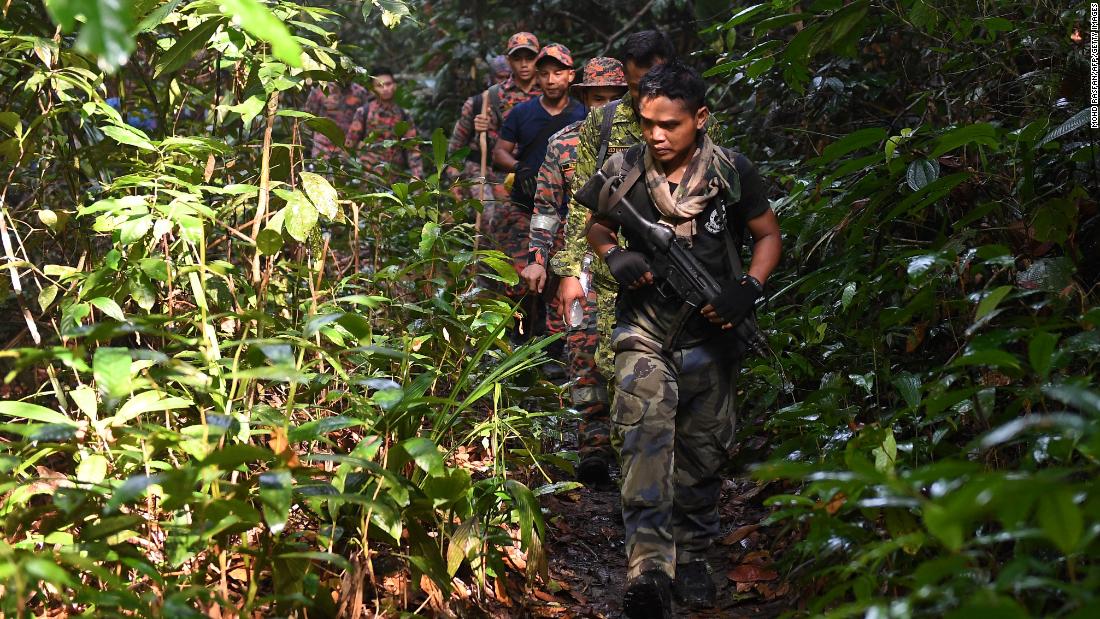 Members of a rescue team take part in the search effort on Monday.