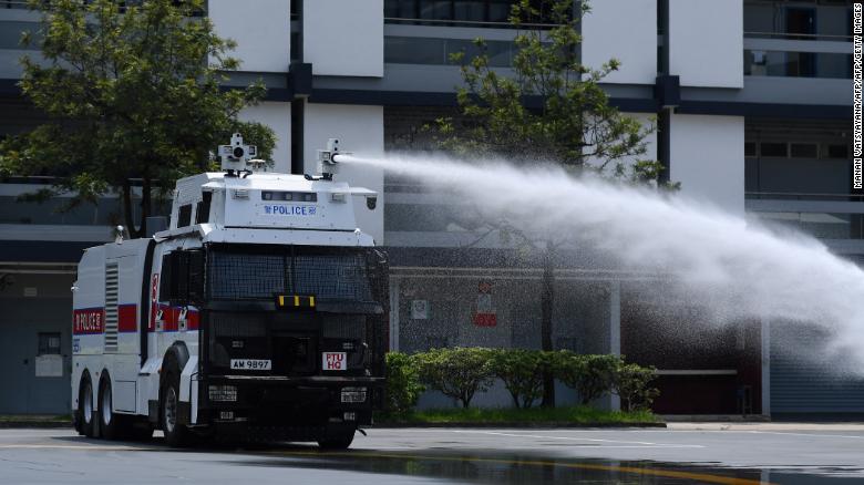 Hong Kong Police demonstrate their new water cannon equipped vehicle at the Police Tactical Unit compound in Hong Kong on August 12, 2019. 