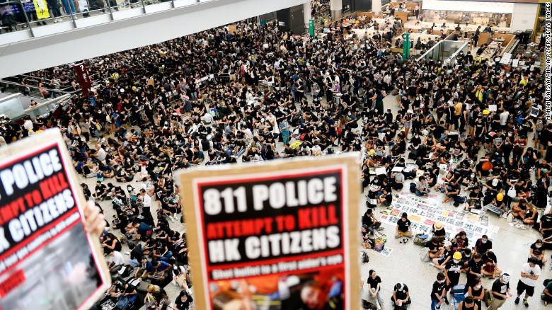 Pro-democracy protesters gather against the police brutality and the controversial extradition bill at Hong Kong&#39;s international airport on August 12, 2019.