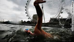 Endurance swimmer and conservationist Lewis Pugh swims in the Thames River in London.