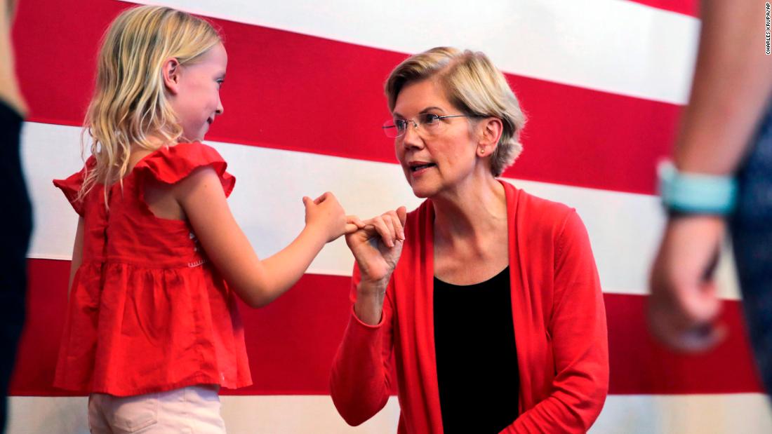 Warren makes a pinky promise with 8-year-old Sydney Hansen during a campaign stop in Peterborough, New Hampshire, in July 2019.