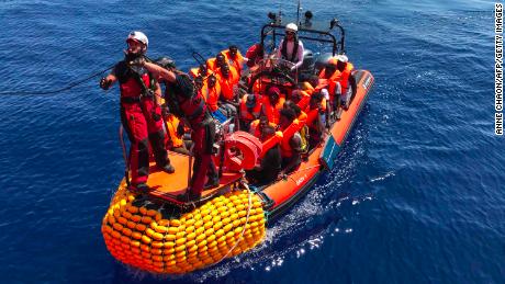 An inflatable dinghy, belonging to the &quot;Ocean Viking&quot; rescue ship, operated by French NGOs SOS Mediterranee and Medecins sans Frontieres (MSF), rescues migrants in the Mediterranean in August 2019.