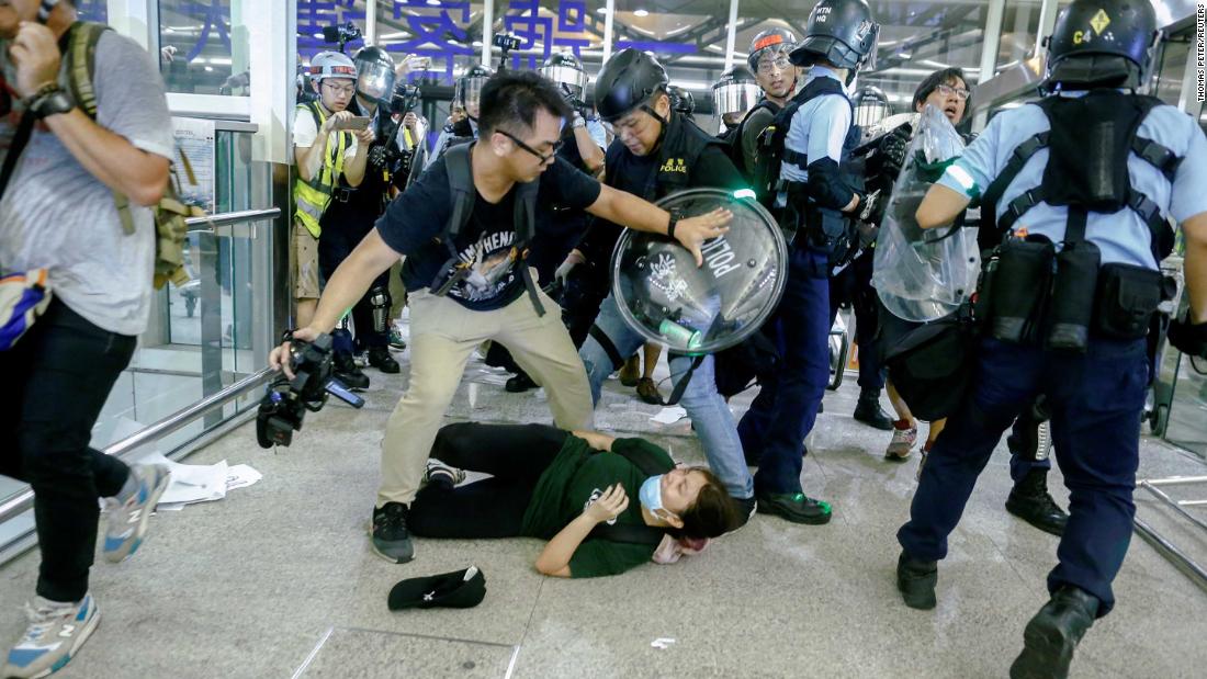 Police and protesters clash at the airport on August 13. The violence came after Hong Kong's Airport Authority announced that all check-in services would be suspended for another night because of terminal operations being "seriously disrupted."