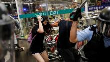 Riot police use pepper spray to disperse anti-extradition bill protesters during a mass demonstration after a woman was shot in the eye, at the Hong Kong international airport, in Hong Kong China August 13, 2019. REUTERS/Tyrone Siu