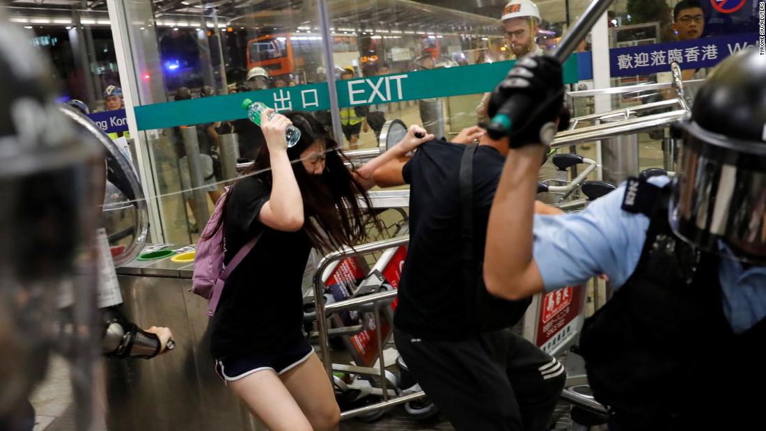 Police use pepper spray to disperse protesters at the airport on August 13.