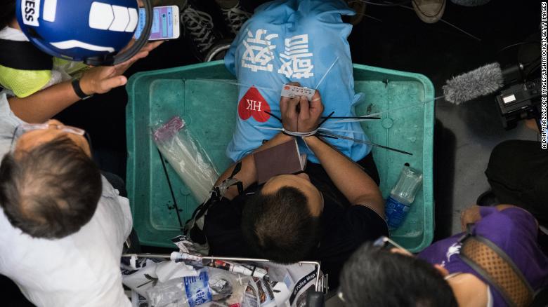 A Global Times reporter is zip-tied during the protest.