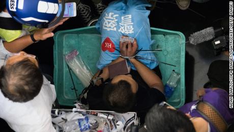 A Global Times reporter is zip-tied during the protest.