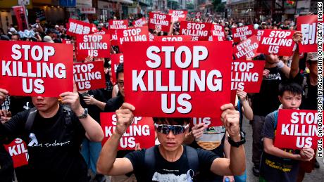 Protesters displaying placards during a march on June 12, 2019.