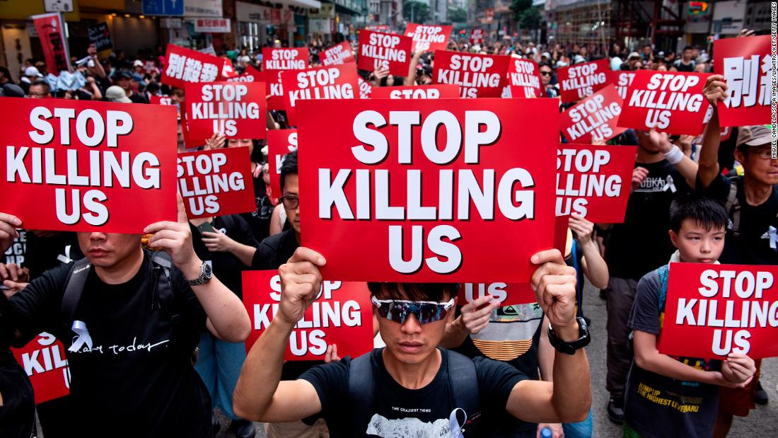 Protesters displaying placards during a march on June 12, 2019.