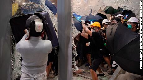 Protesters shatter glass to get inside the Hong Kong&#39;s legislature building during a demonstration on July 1, 2019. 