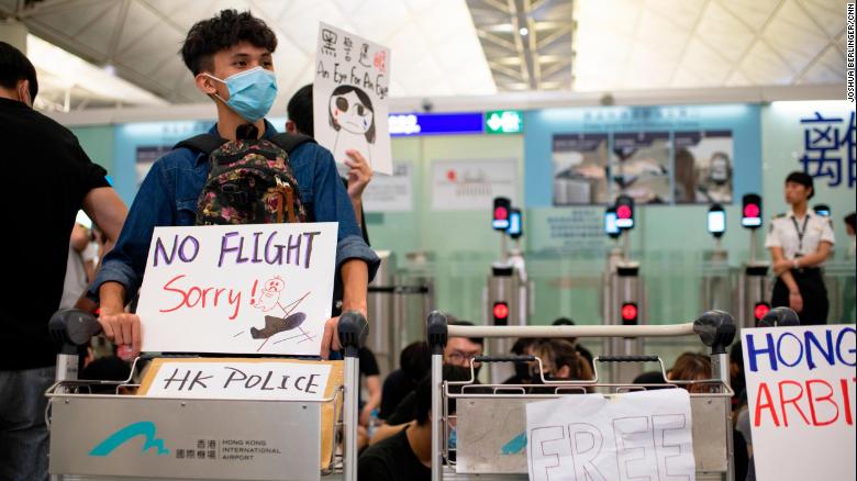 Protesters at Hong Kong International Airport block the entrance to the security checkpoint on Tuesday, August 13.