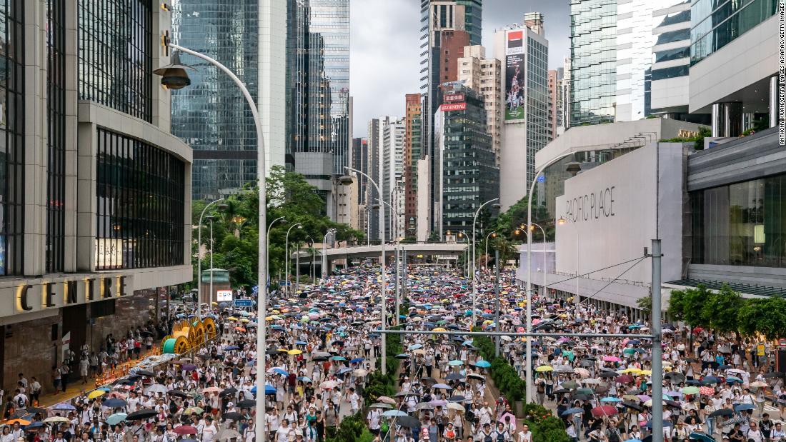 Protesters march on a street during a rally against a controversial extradition law proposal on June 9, 2019.