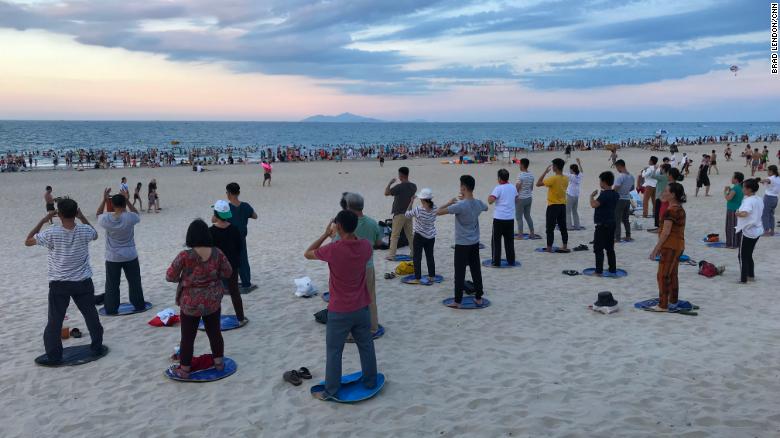 Locals gather for a tai chi and swimming on My Khe beach in Da Nang, Vietnam. During the Vietnam War, the Americans called this China Beach.