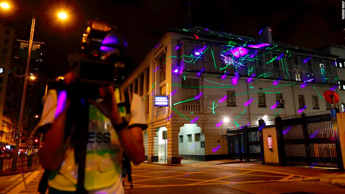 Protesters point lasers at the Sham Shui Po police station on August 14.