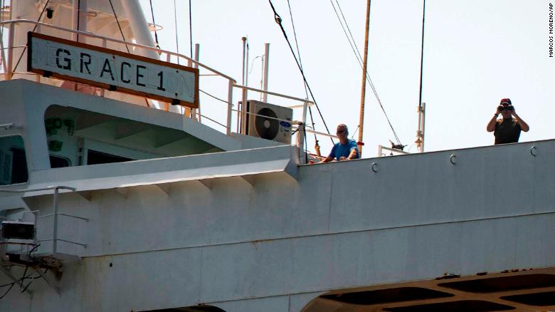 Crew members stand on the Grace 1 supertanker earlier on Thursday. 