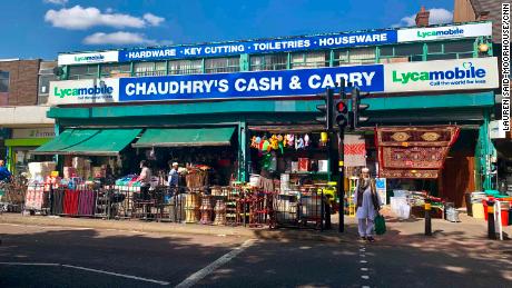 A man waits at a cross walk on Coventry Road in the Small Heath area of Birmingham.