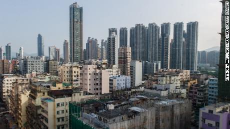 TO GO WITH HongKong-housing-social-rooftop,FEATURE by Laura MANNERING
This photograph taken on October 10, 2013 shows the residential building (bottom C) upon which residents Su Xingyun and Quang Xuan live in their rooftop houses in the Sham Shui Po district of Hong Kong.   Their precarious rooftop houses have for years offered refuge from an unaffordable Hong Kong property market, but some of the city&#39;s poorest residents now face losing their makeshift homes as the government seeks to dismantle them.       AFP PHOTO / ANTHONY WALLACE        (Photo credit should read ANTHONY WALLACE/AFP/Getty Images)