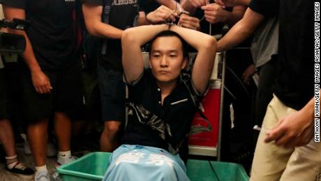 Global Times reporter Fu Guohao, who was suspected of being a Chinese spy, is tied up by protesters at the Hong Kong International Airport during a demonstration on August 13, 2019.