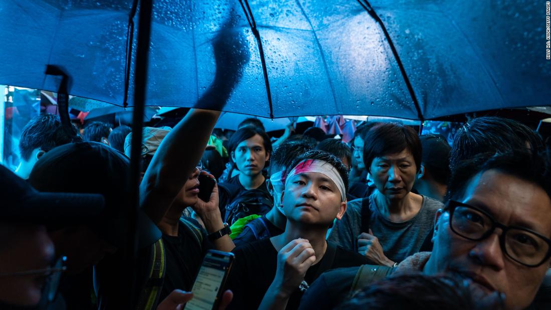 Protesters march under umbrellas on Sunday, August 18.