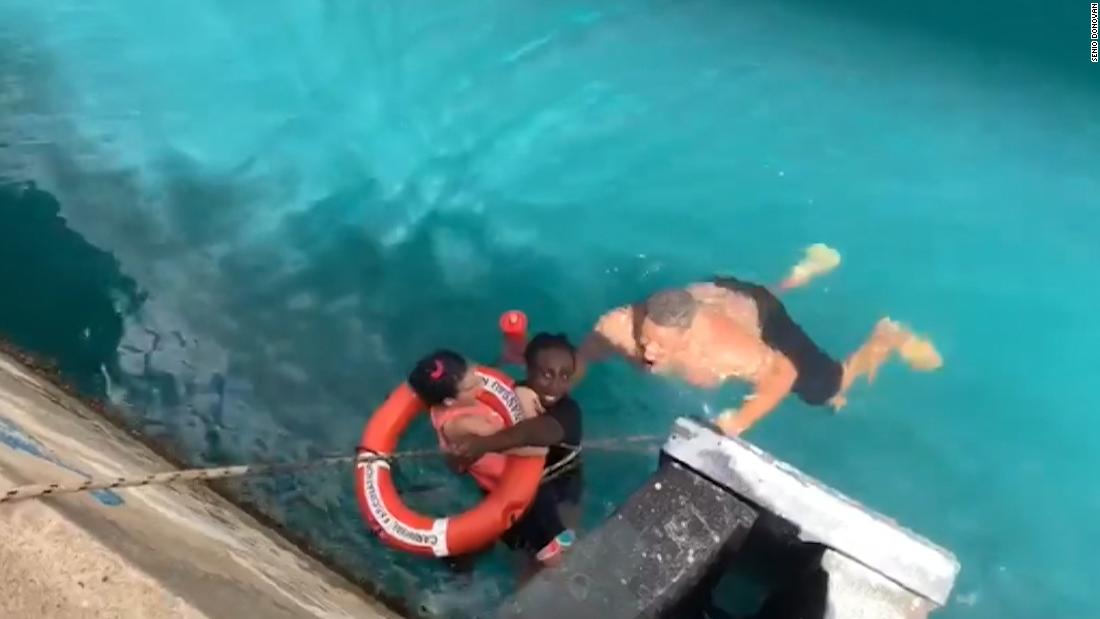 Two men rescued a wheelchairbound cruise ship passenger who fell off a