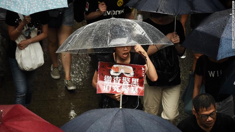 Protesters walk along a street during a rally in Hong Kong on August 18, 2019, in the latest opposition to a planned extradition law.