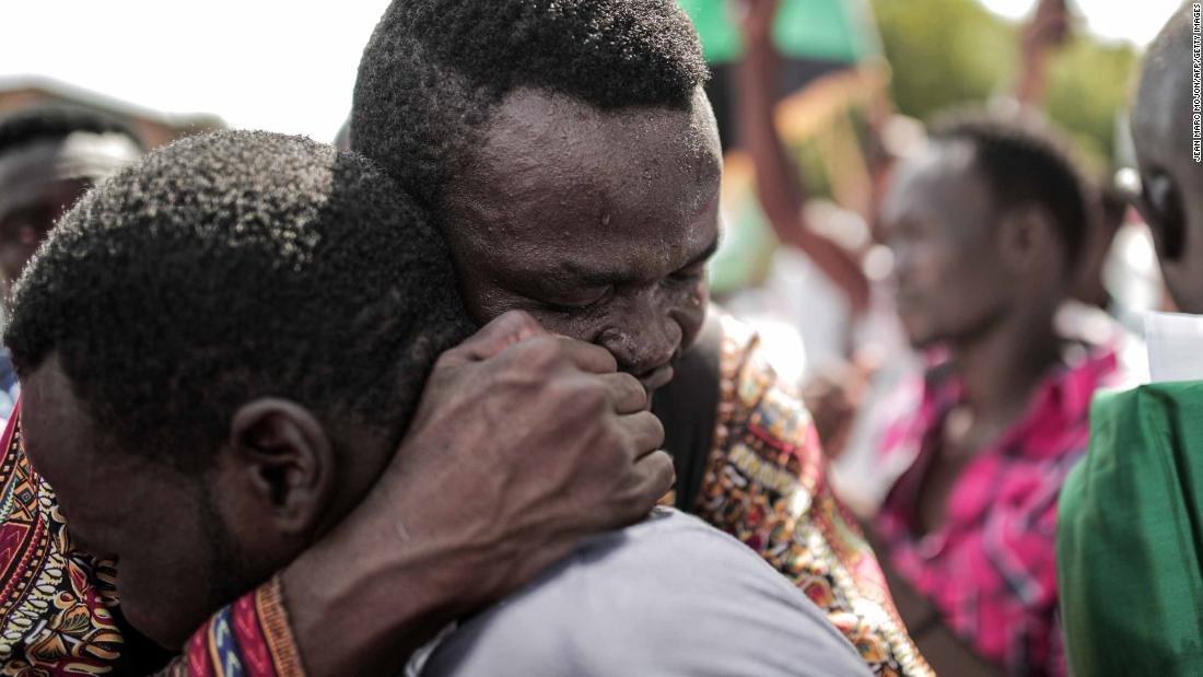Sudanese men embrace outside the Friendship Hall in Khartoum where generals and protest leaders signed a historic transitional constitution, paving the way for civilian rule in Sudan.