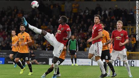 Paul Pogba (C) attempts to control the ball during the English Premier League football match between Wolverhampton Wanderers and Manchester United.
