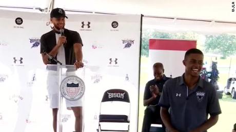 Steph Curry, left, and student Otis Ferguson, right, smile at the announcement of the Howard University golf program.