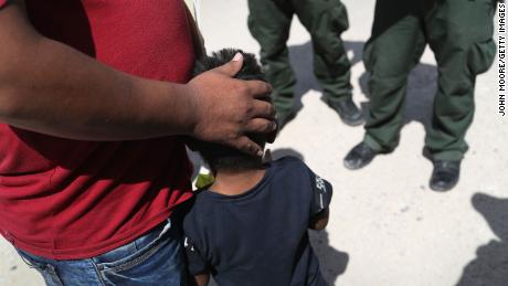 U.S. Border Patrol agents take a father and son from Honduras into custody near the U.S.-Mexico border on June 12, 2018 near Mission, Texas. 