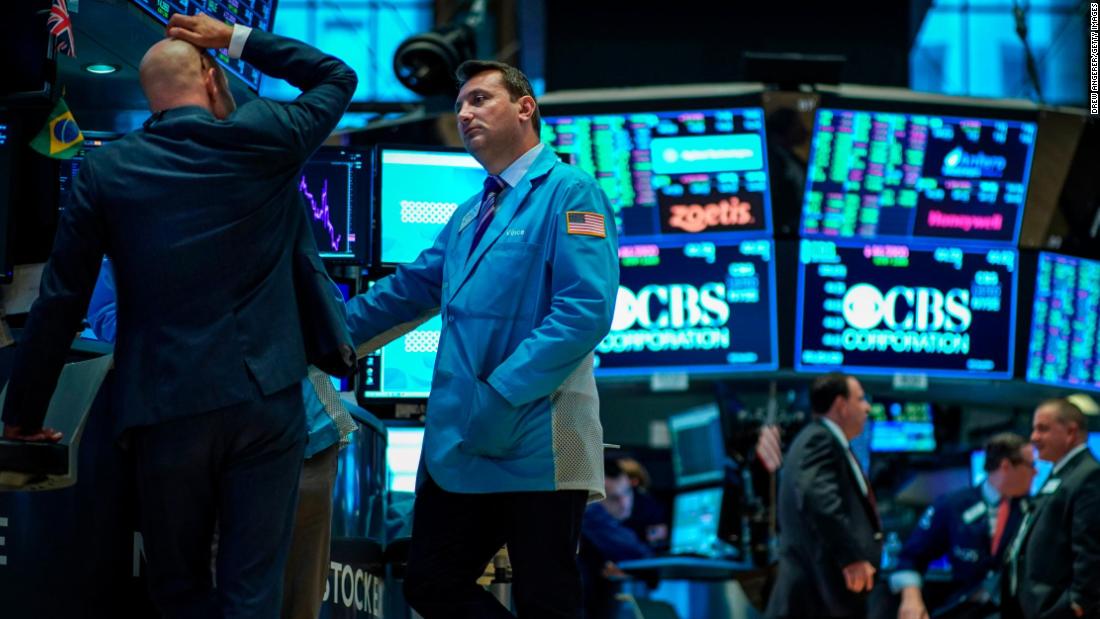 Dow ekes out gain even as bond market flashes another recession warning