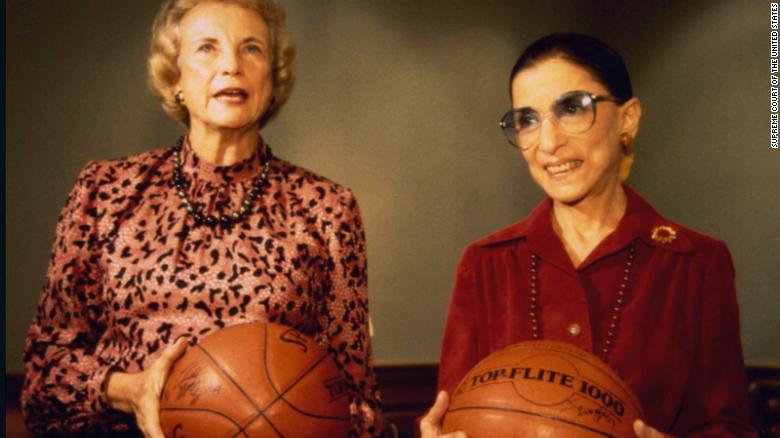 Ginsburg and fellow Justice Sandra Day O'Connor hold basketballs given to them by the US women's basketball team in December 1995.