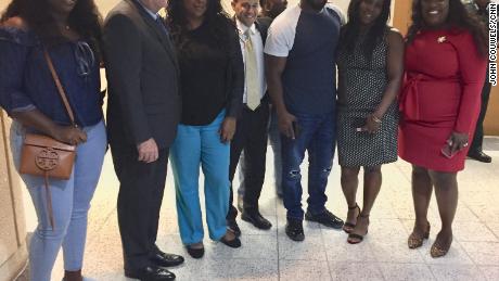 The McGlockton family takes a picture with the prosecuting attorneys outside the courtroom Friday night in Clearwater, Florida.