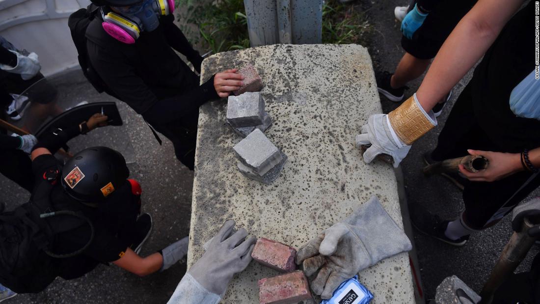 Protesters pick up bricks to be used as projectiles on August 24.&lt;br /&gt;