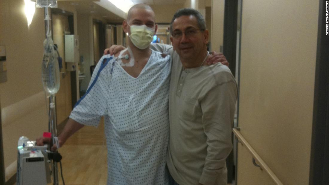 David Fajgenbaum poses with his father during one of his hospital stays.