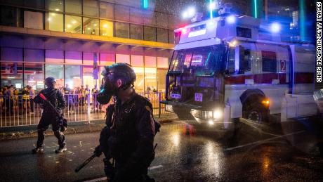 A police water cannon drives toward protesters on August 25.