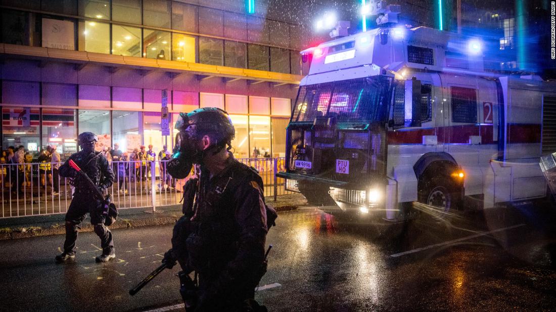 A police water cannon drives toward protesters on August 25.