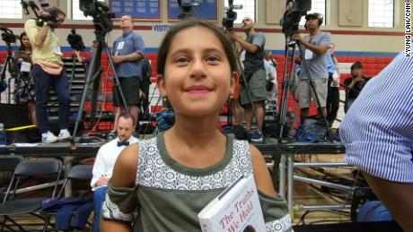 Katerina Shadrach holds a book by Kamala Harris as she waits to see the senator take the stage.