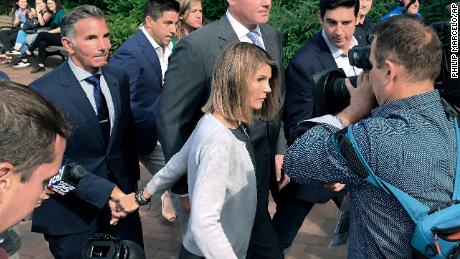 Lori Loughlin depart federal court with her husband, clothing designer Mossimo Giannulli, left, on Tuesday, Aug. 27, 2019, in Boston, after a hearing in a nationwide college admissions bribery scandal. (AP Photo/Philip Marcelo)